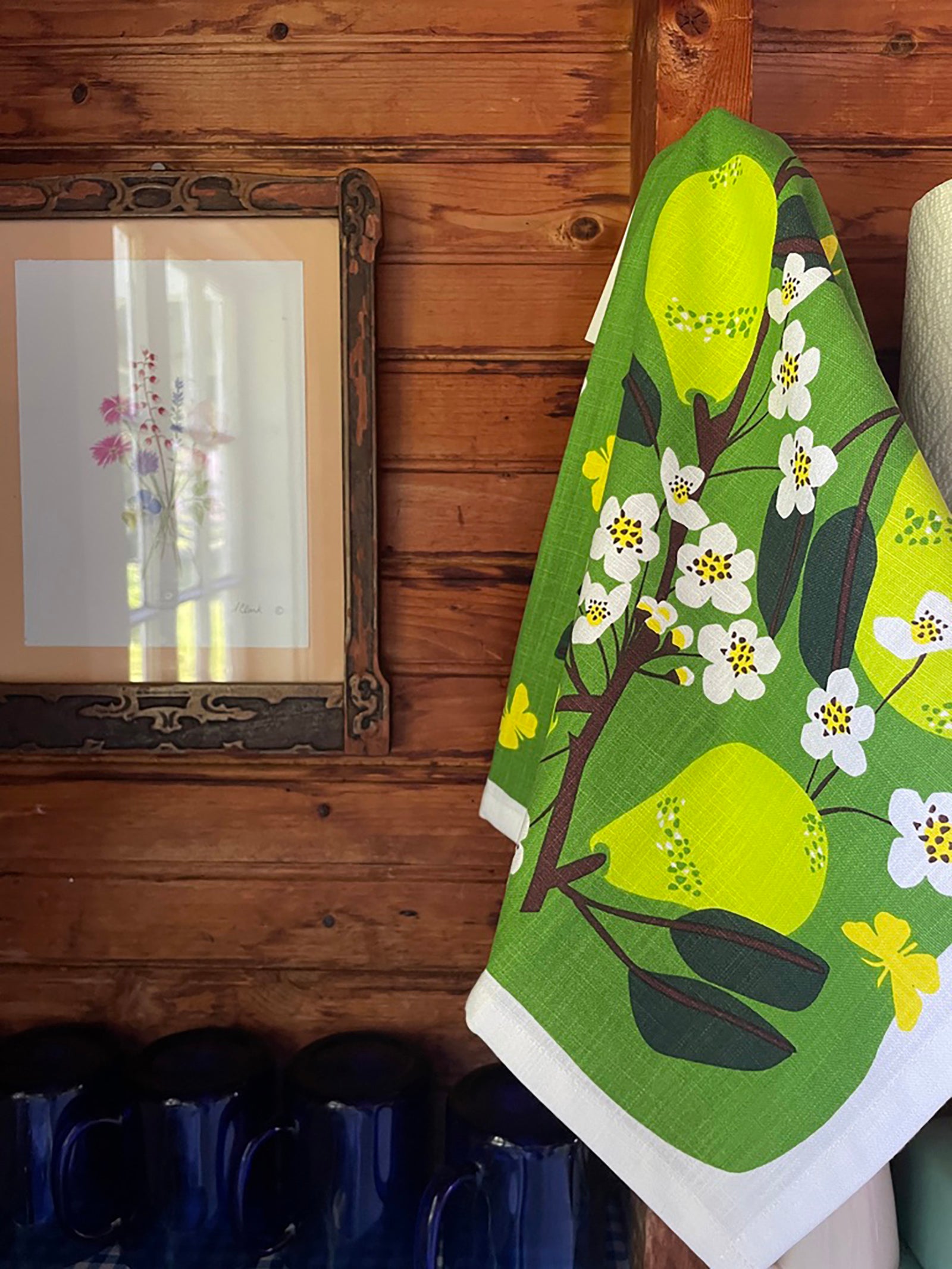 pear and floral tea towel front hung up
